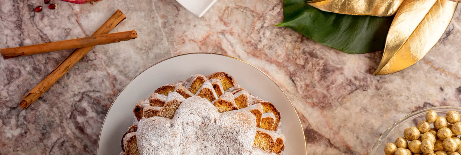 Selection of Christmas desserts with pandoro, cinnamon, pomegranate, chocolate and candied fruit at Hotel Eden, Rome