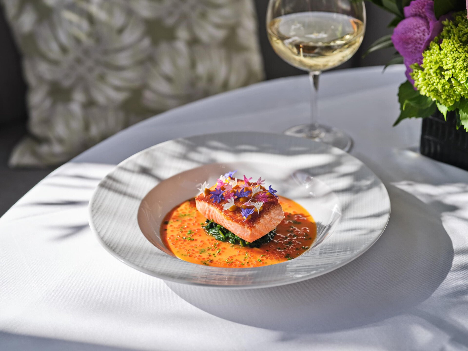 Bright orange salmon with greens main dish from The Restaurant at Hotel Bel-Air