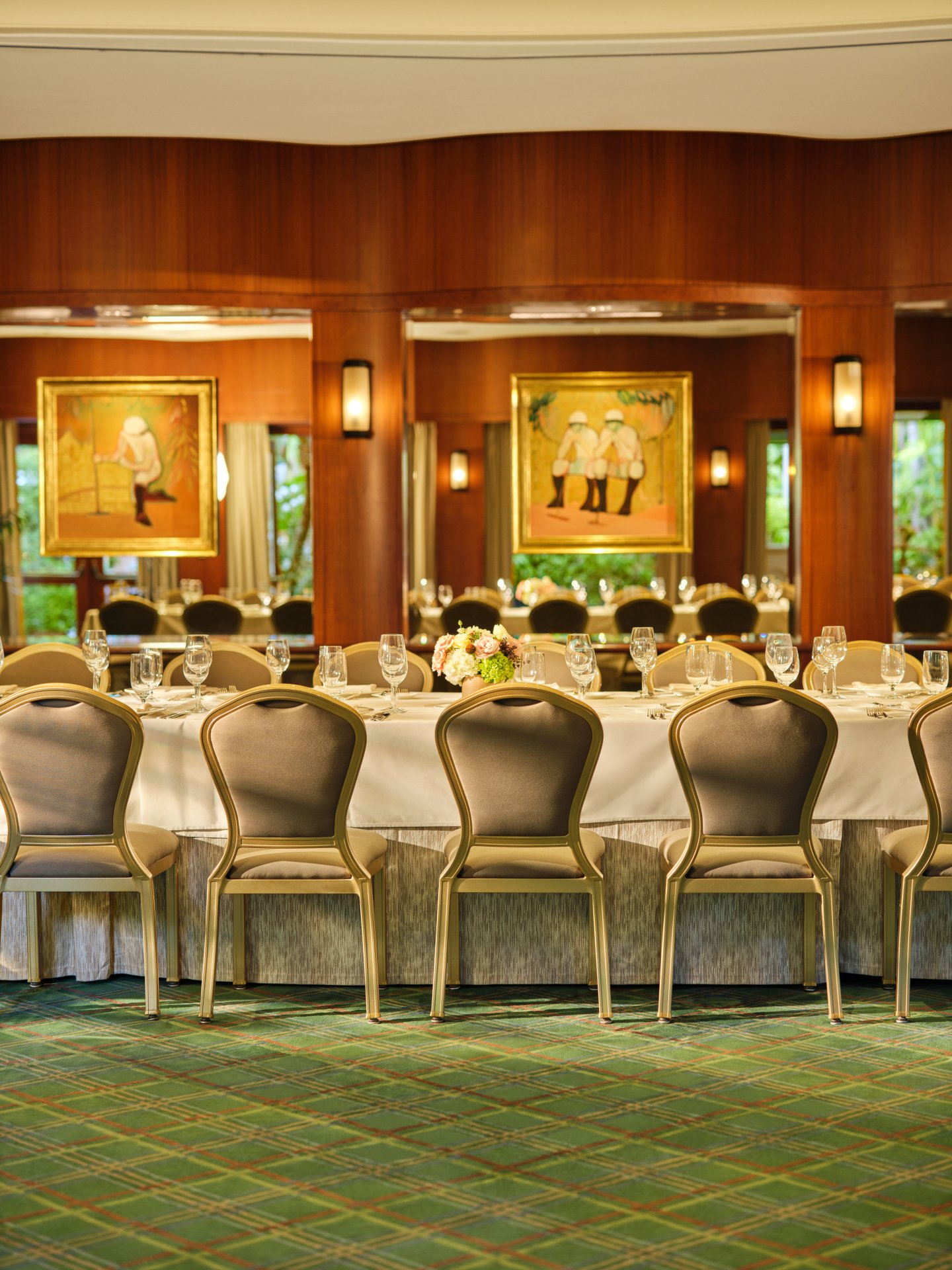 Elegant banquet table set for a formal event in a warmly decorated restaurant.
