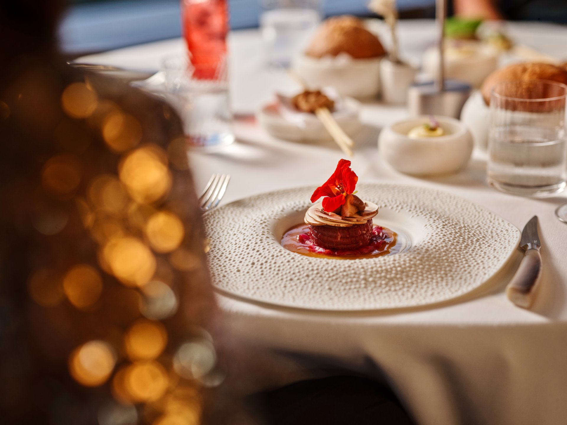 Elegant dining table with a beautifully plated dessert and soft ambient lighting