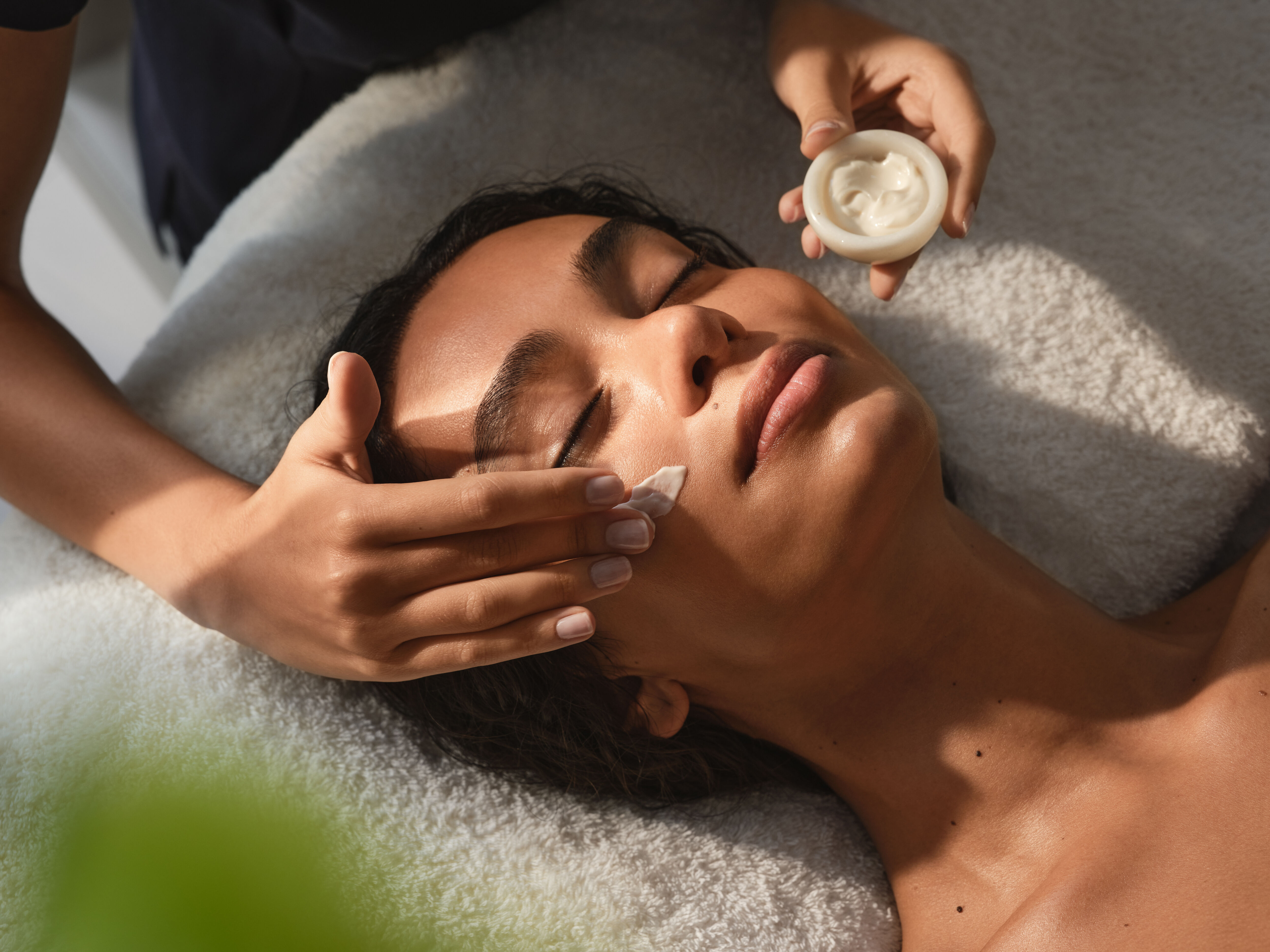 Guest receiving a facial treatment at The Spa at Coworth Park, a Dorchester Collection hotel