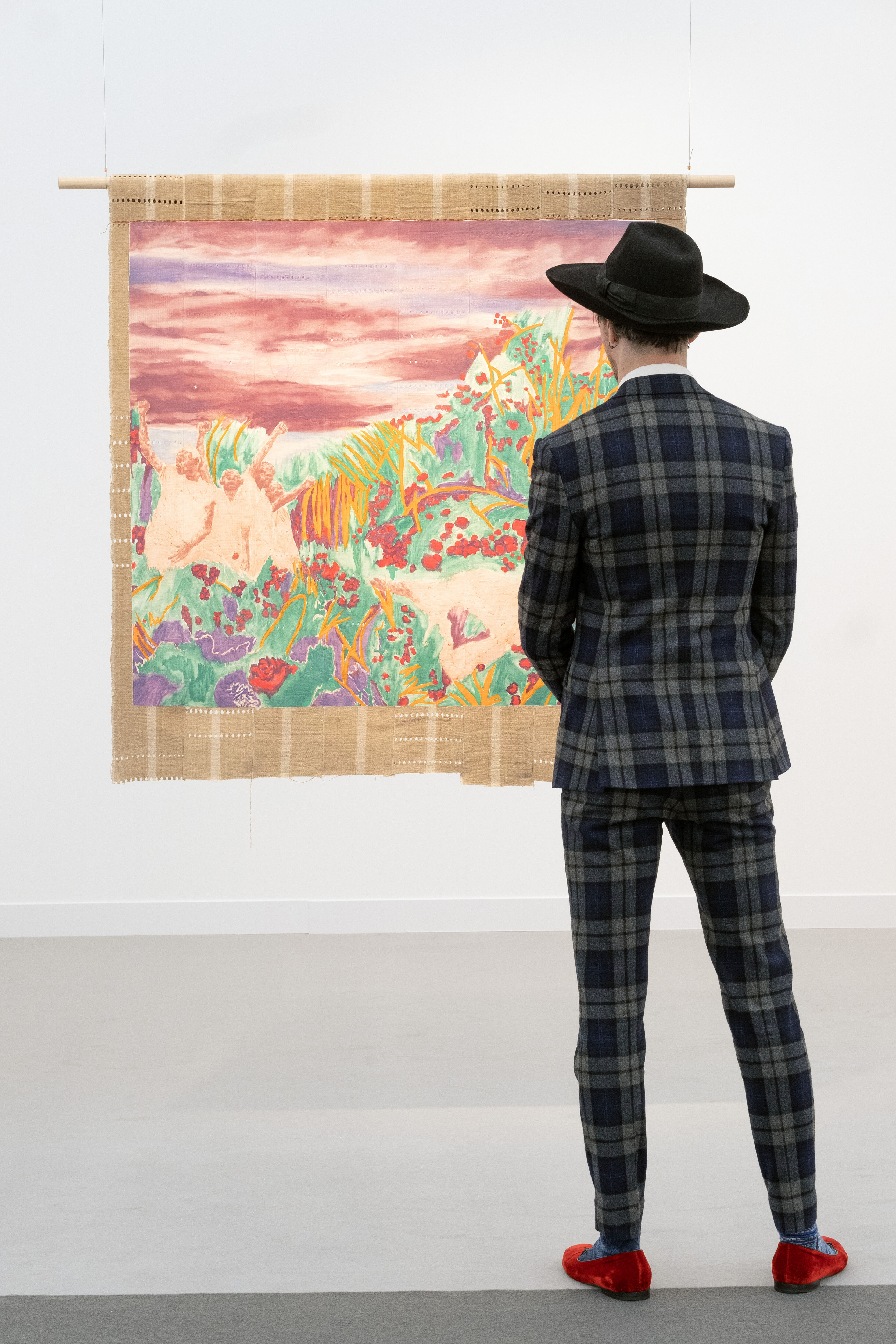 A male model lookinh at the art during Frieze Art Fair