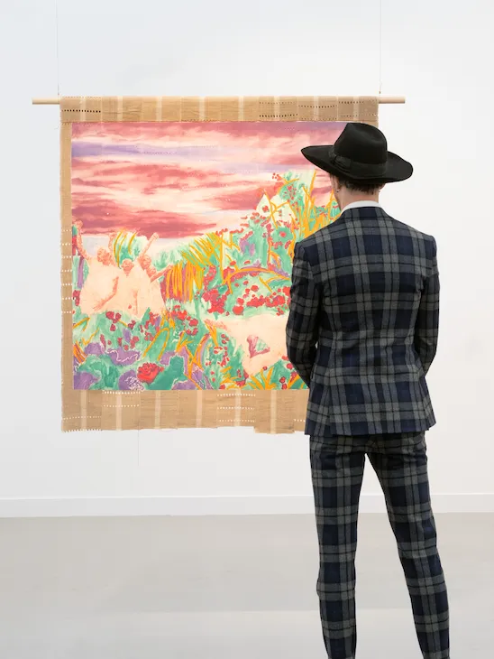 A male model lookinh at the art during Frieze Art Fair