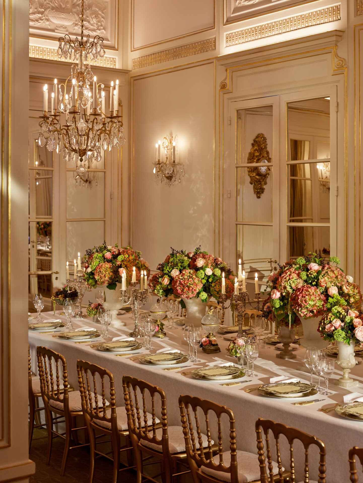 Dinner captured with gold and white tableware, pink and green flowers, green cakes, at Le Salon Organza, at Hôtel Plaza Athénée, Paris - Dorchester Collection.