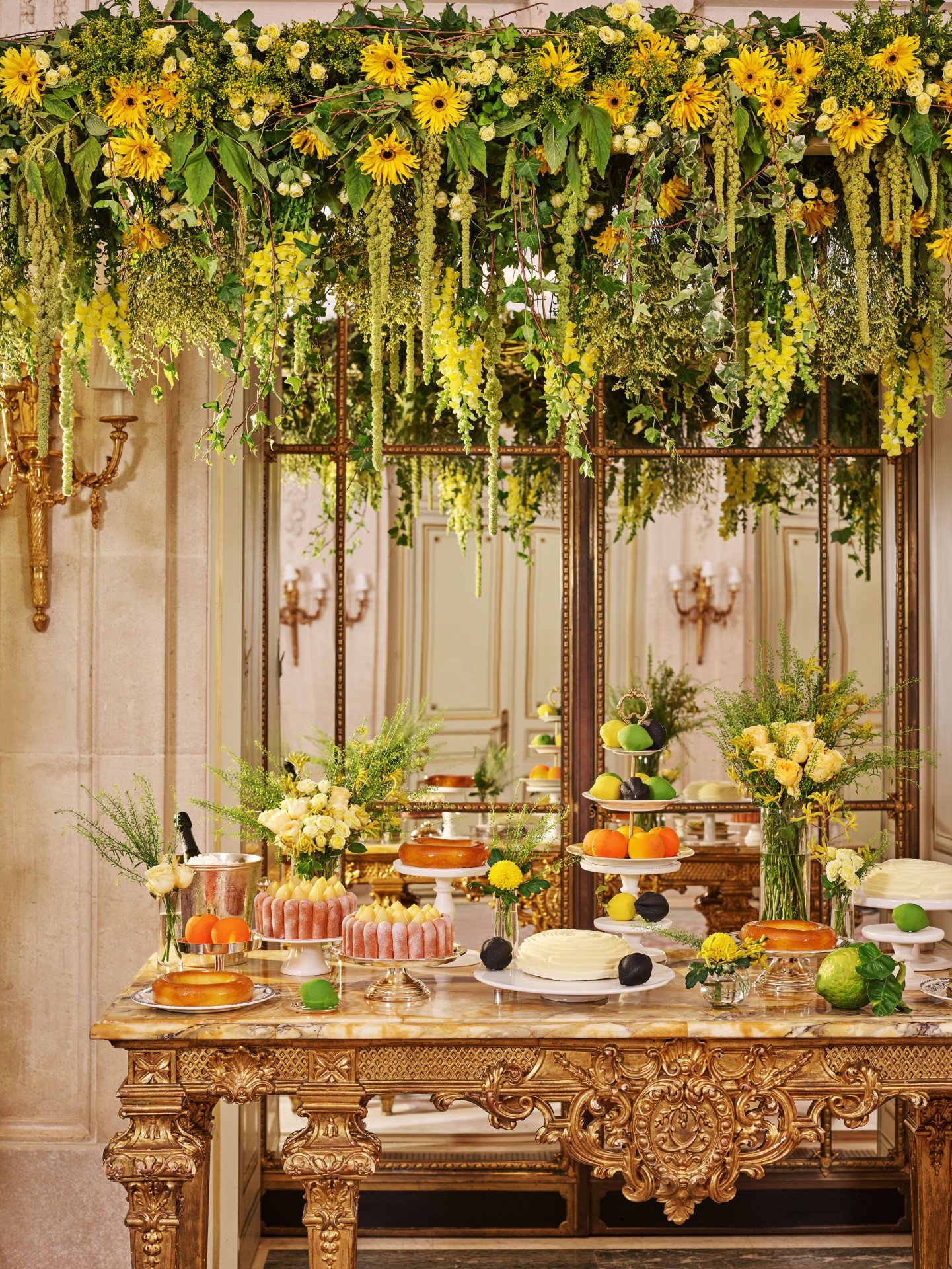 Pastries Buffet details with flower bouquet and a decorative plant arch in the Salon Tuileries at Le Meurice - Dorchester Collection