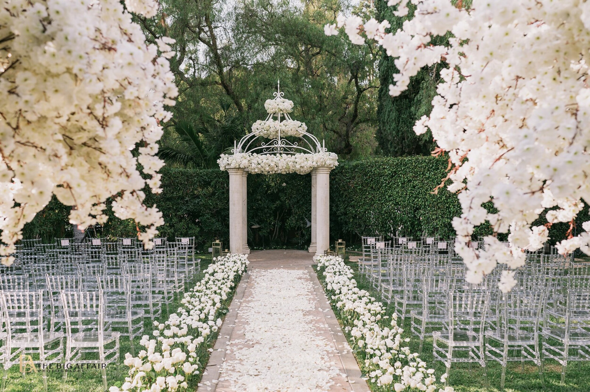 Outdoor wedding ceremony in Crystal Garden with white floral at The Beverly Hills Hotel