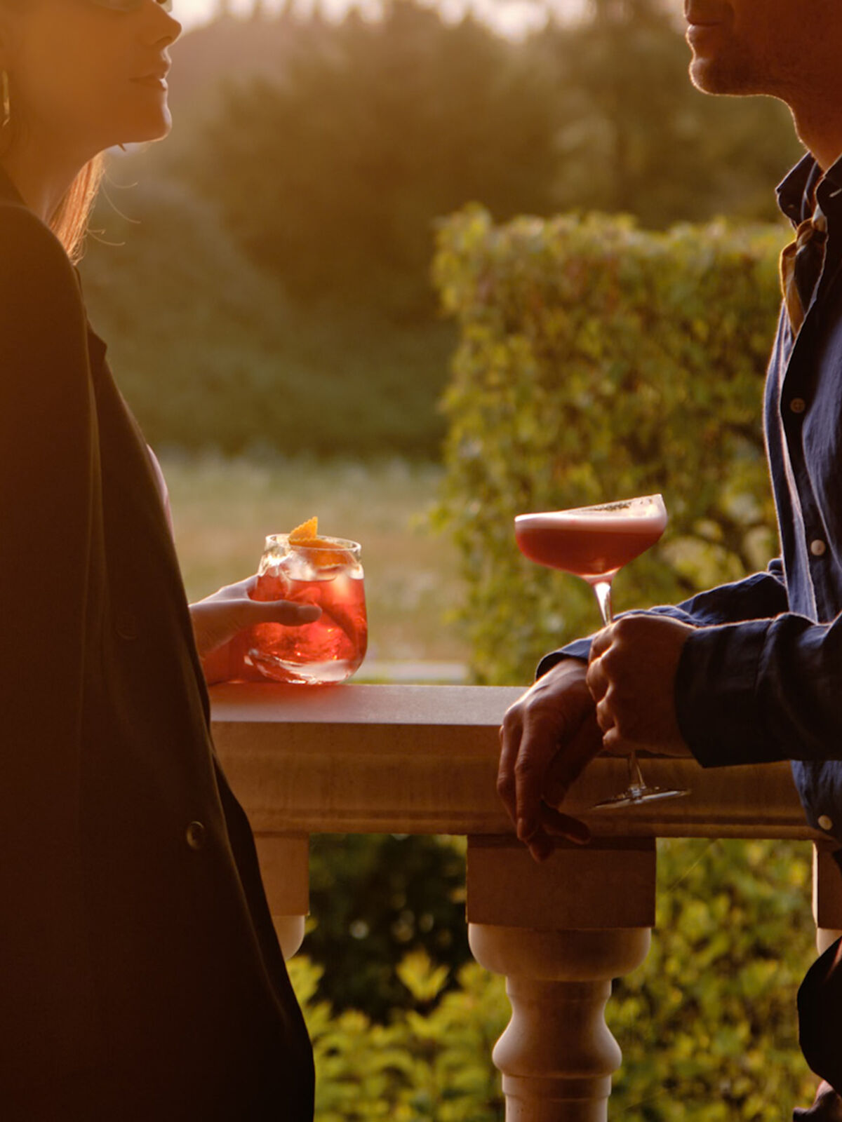Guests enjoying cocktails on the terrace at sunset at Coworth Park ,Ascot