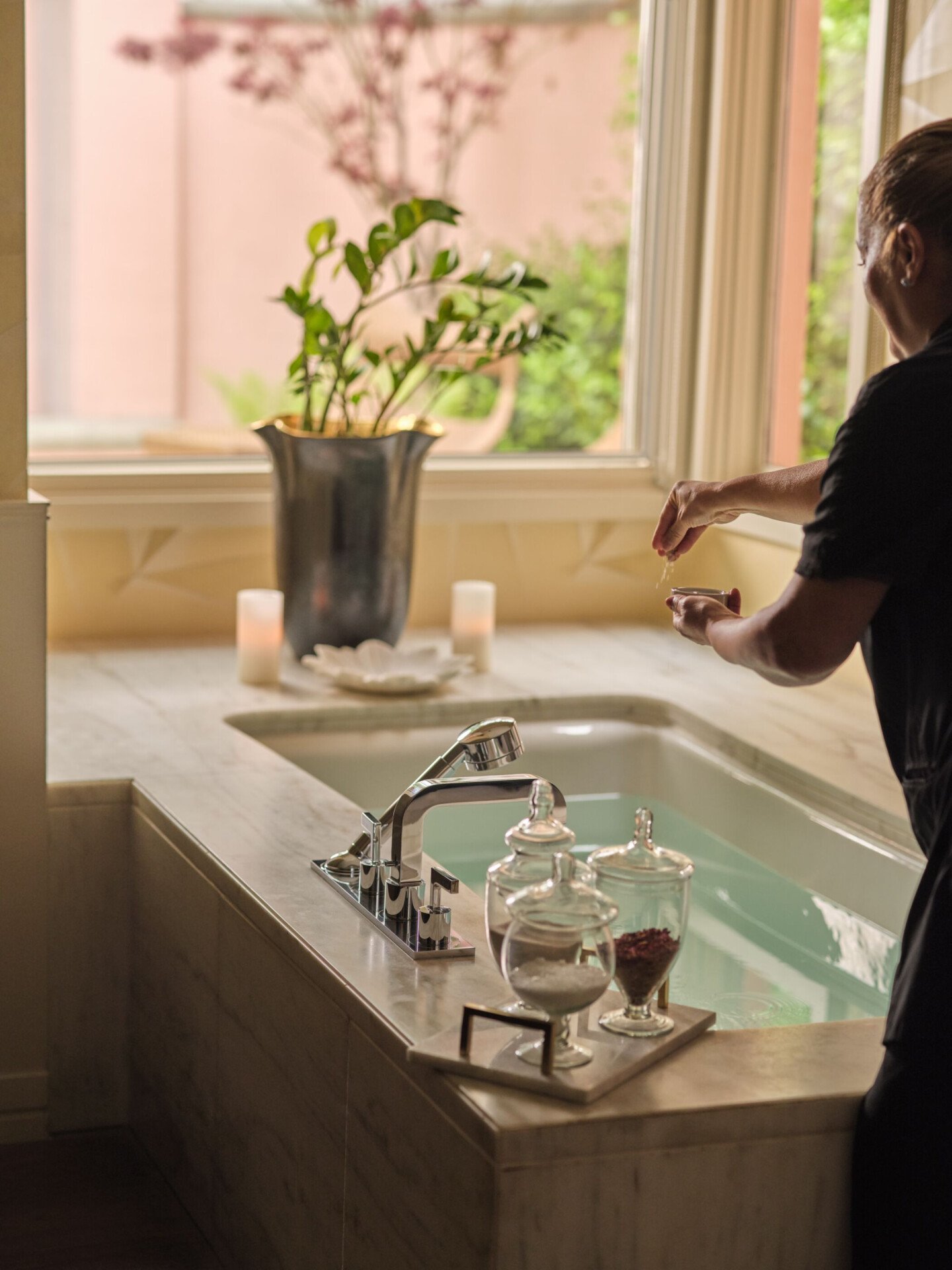 therapist prepping bathtub in couples treatment room 