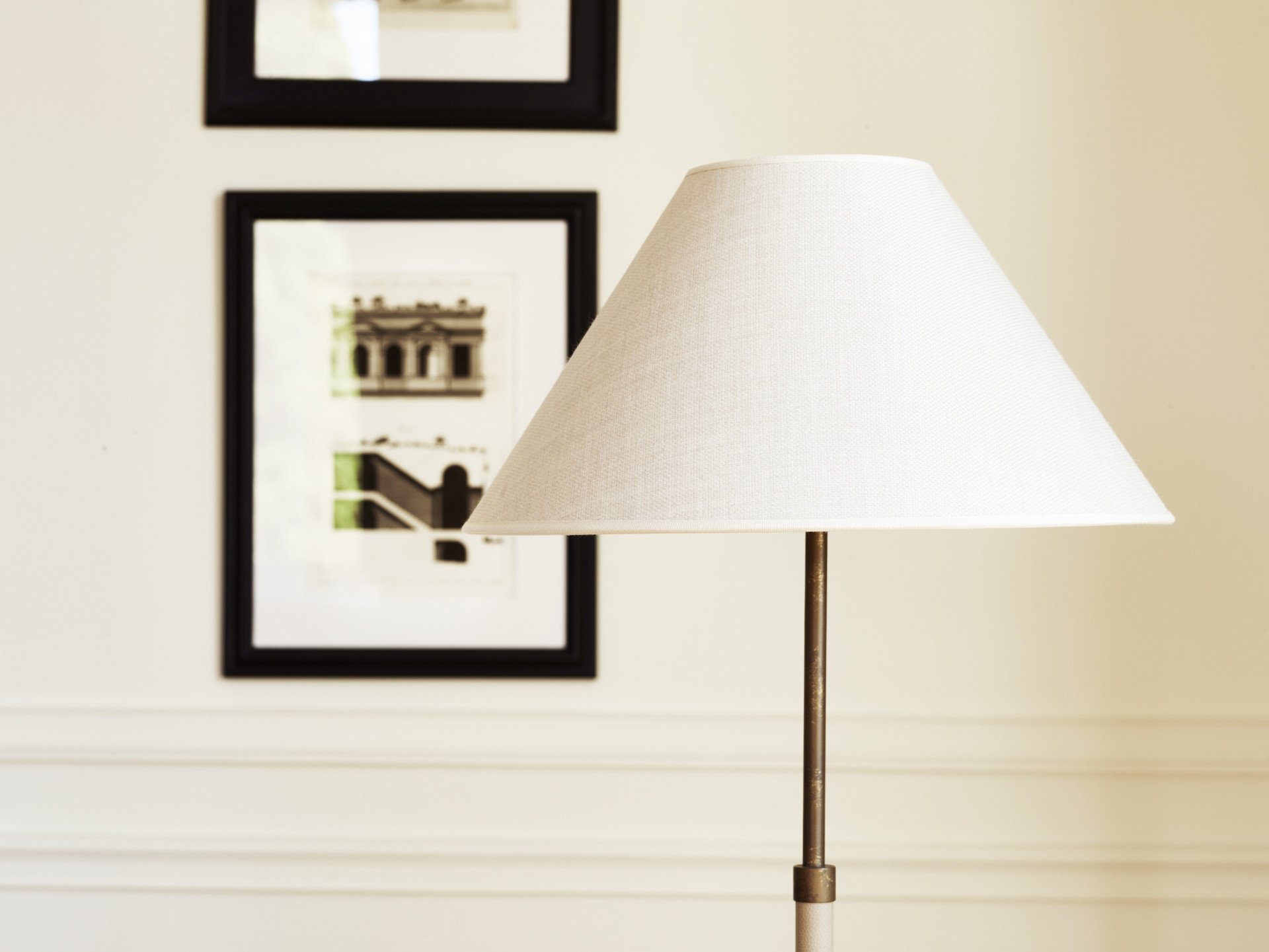 Lampada con paralume davanti a due stampe appesa ad una parete della Suite Dolce Vita a Hotel Eden