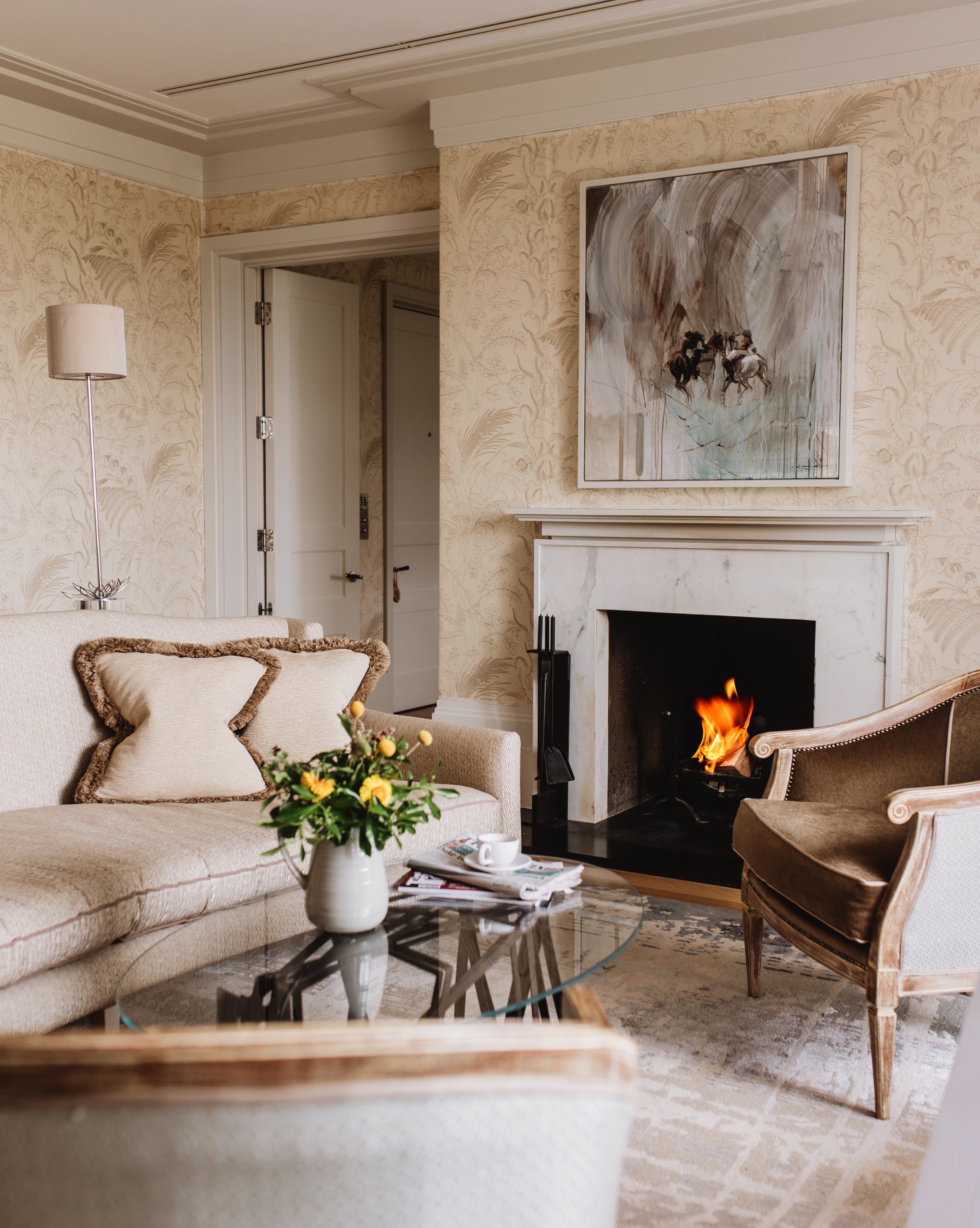 Mansion House suite with marble fireplace and elegant seating at Coworth Park, Ascot