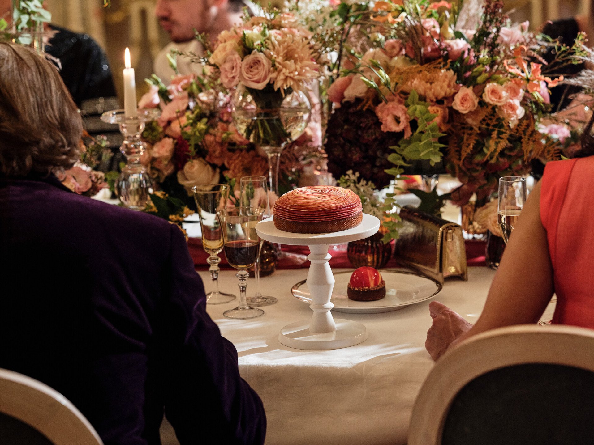 Apple rose tart, on a table with floral arrangement in Le Salon Pompadour at Le Meurice, Paris - Dorchester Collection