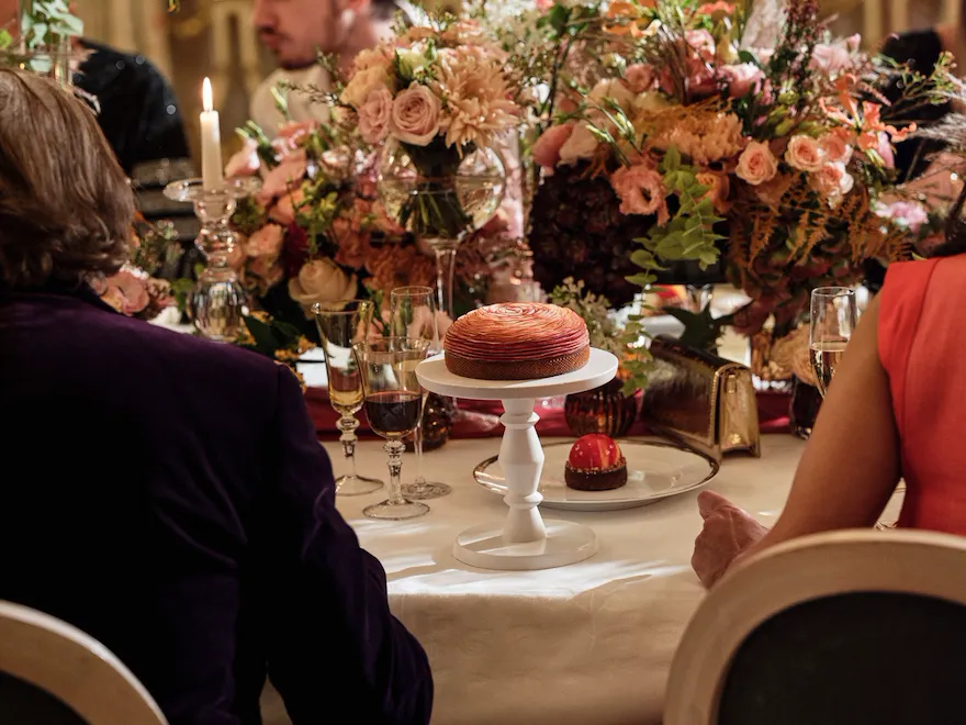 Apple rose tart, on a table with floral arrangement in Le Salon Pompadour at Le Meurice, Paris - Dorchester Collection