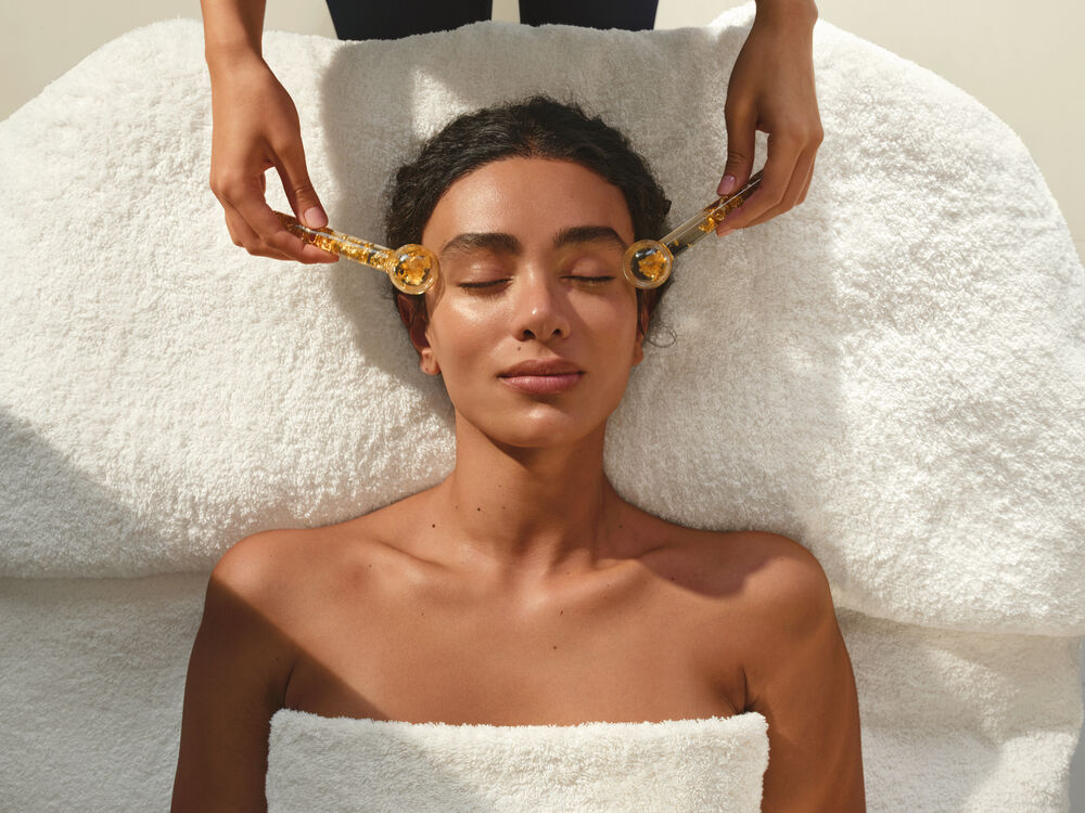 Person having Spa Treatment Facial with Ice Globes 