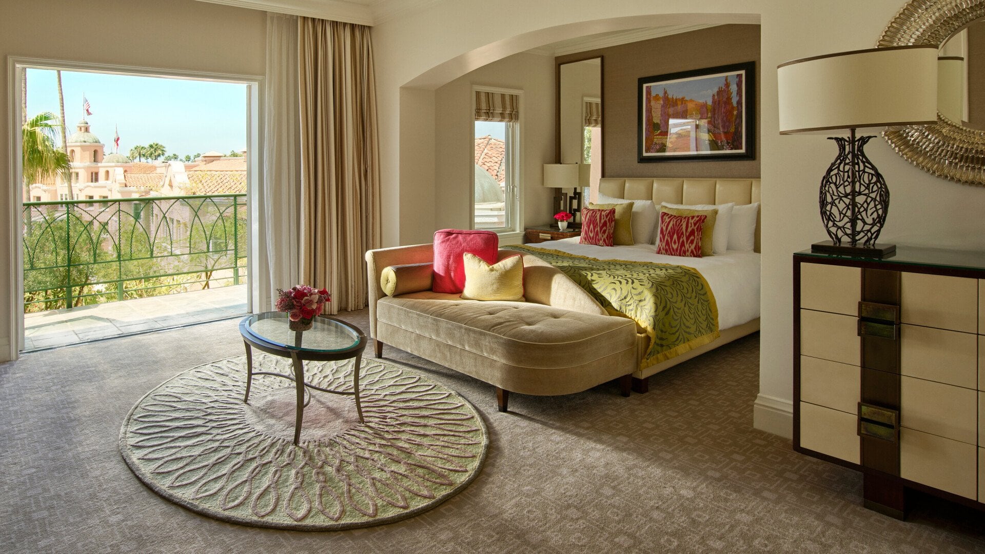 Deluxe guestroom with balcony, view of king bed and blue skies