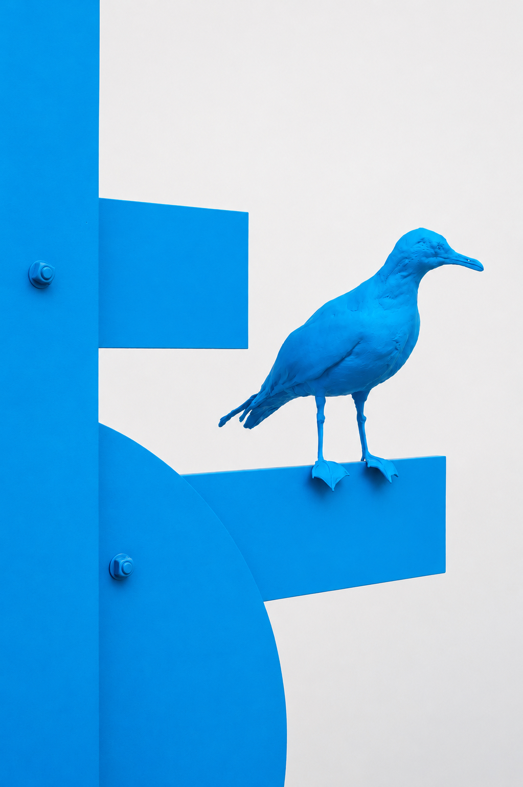 Artist, Nathan Mabry's blue sculpture of a bird perched on a structure. 