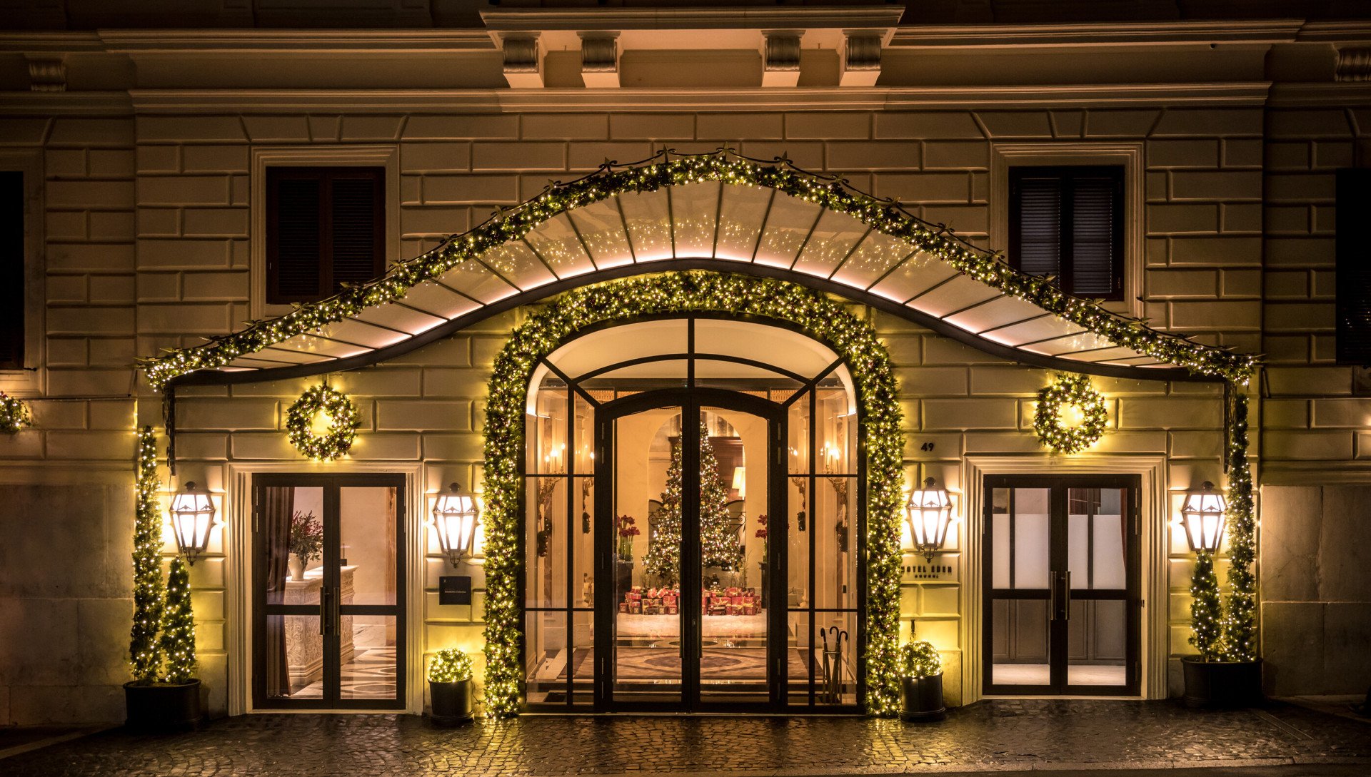 Night shot of Hotel Eden's exterior with Christmas decorations