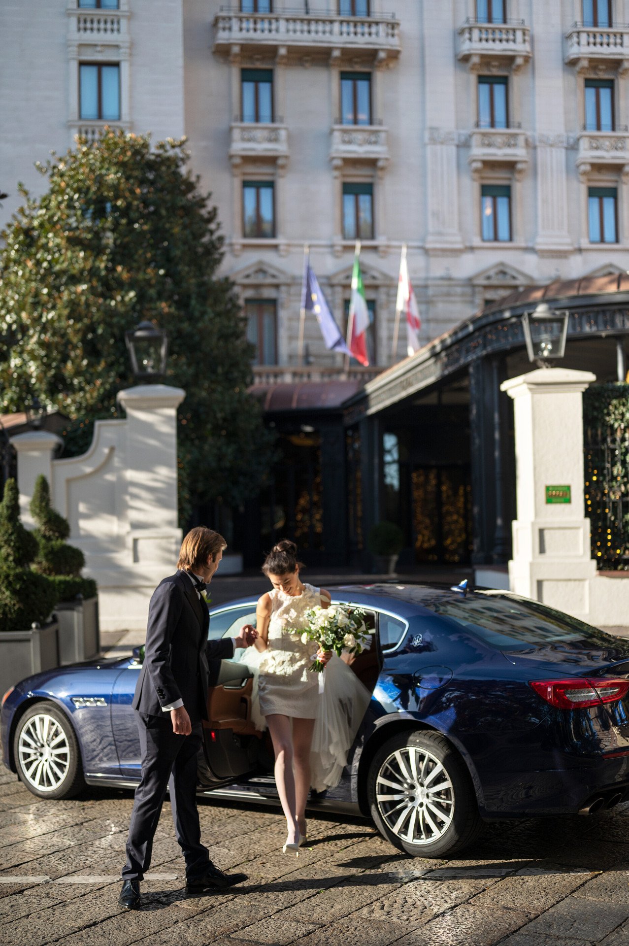Couple outside in front the facade entering the hotel