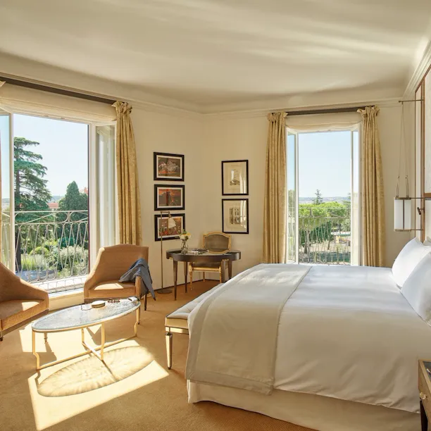 Junior Suite bedroom with windows open to view at Hotel Eden, Rome