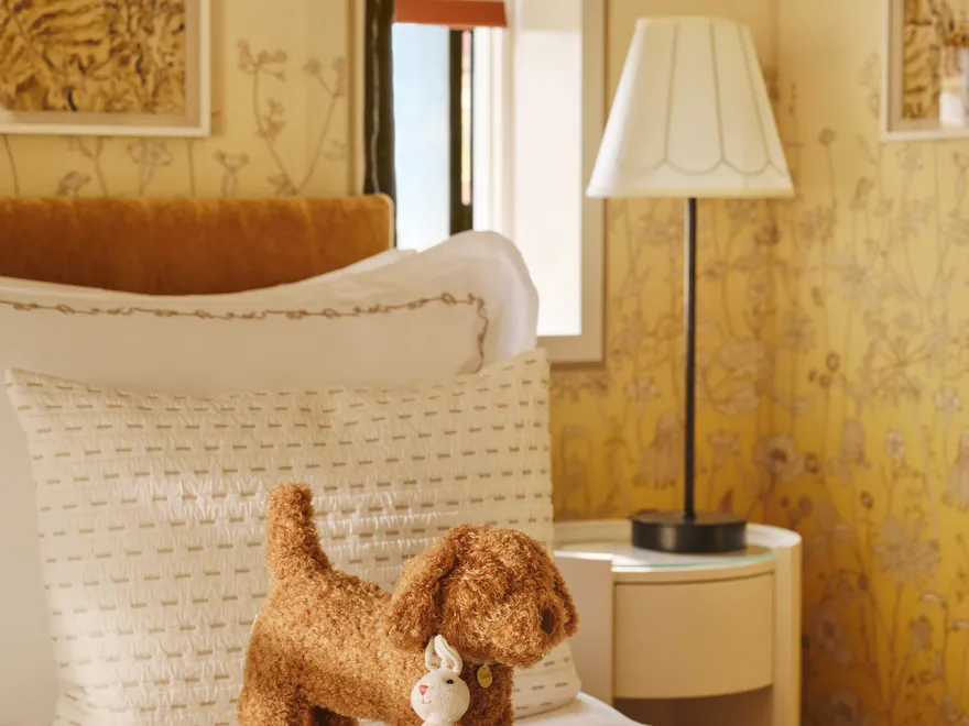 Children's bedroom with soft toys and botanical wallpaper in the Gardeners West suite at Coworth Park, Ascot