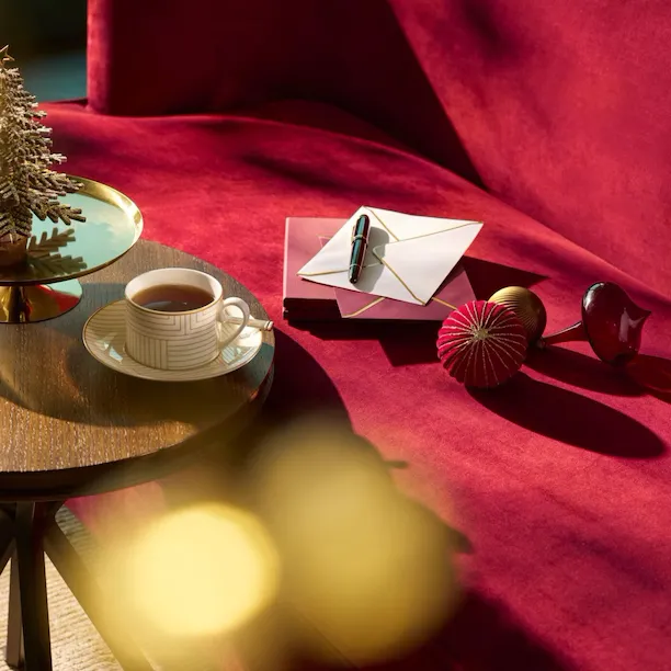 Decorated table in the room with a coffee on top.