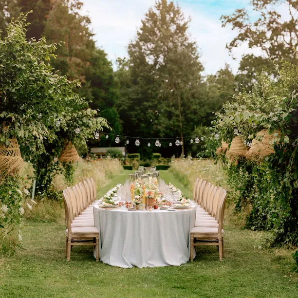Outdoor dinner setting in the meadow at Coworth Park, Ascot