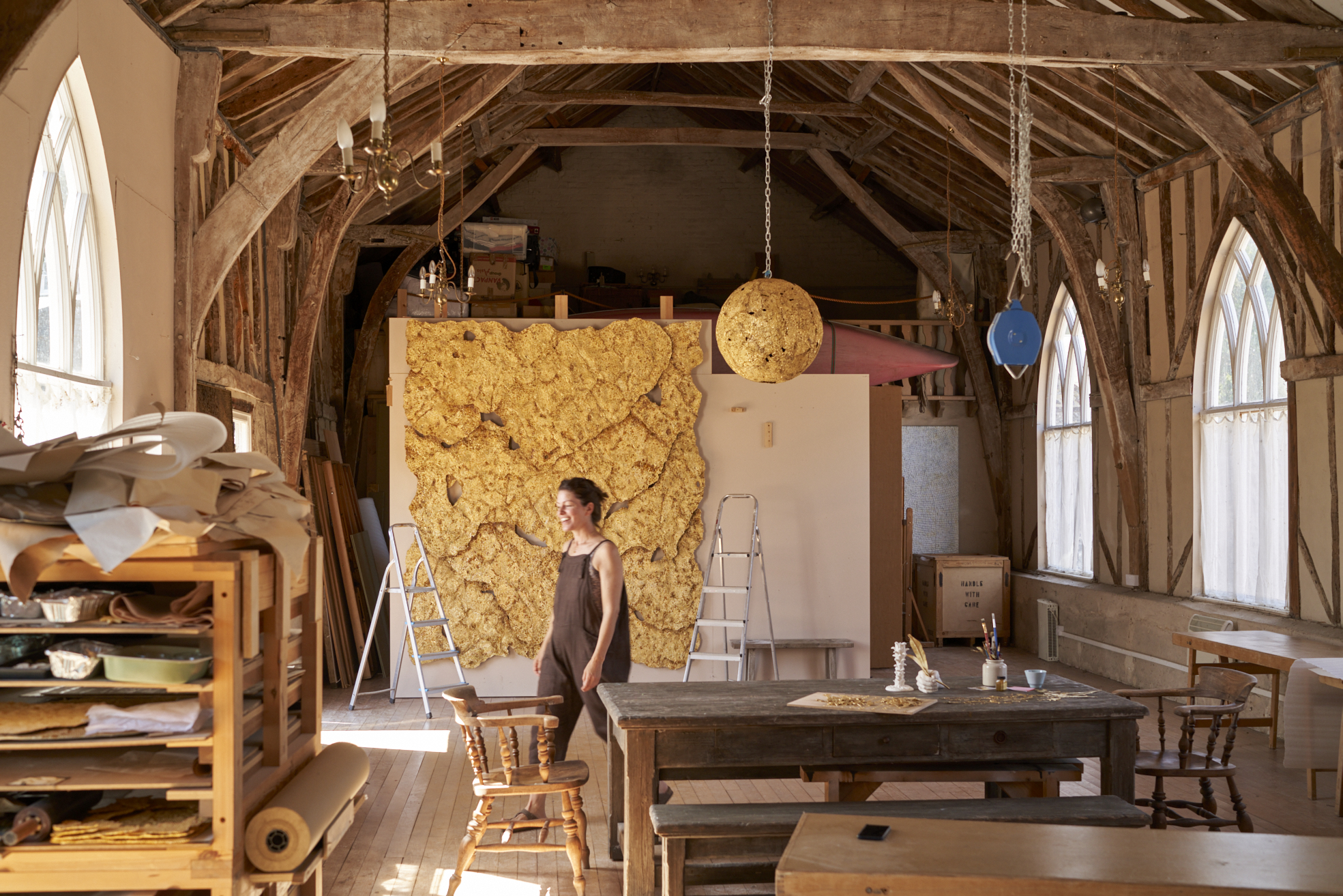 Sophie Coryndon artist in her studio in front of 'The Dorchester Dossel' artwork 