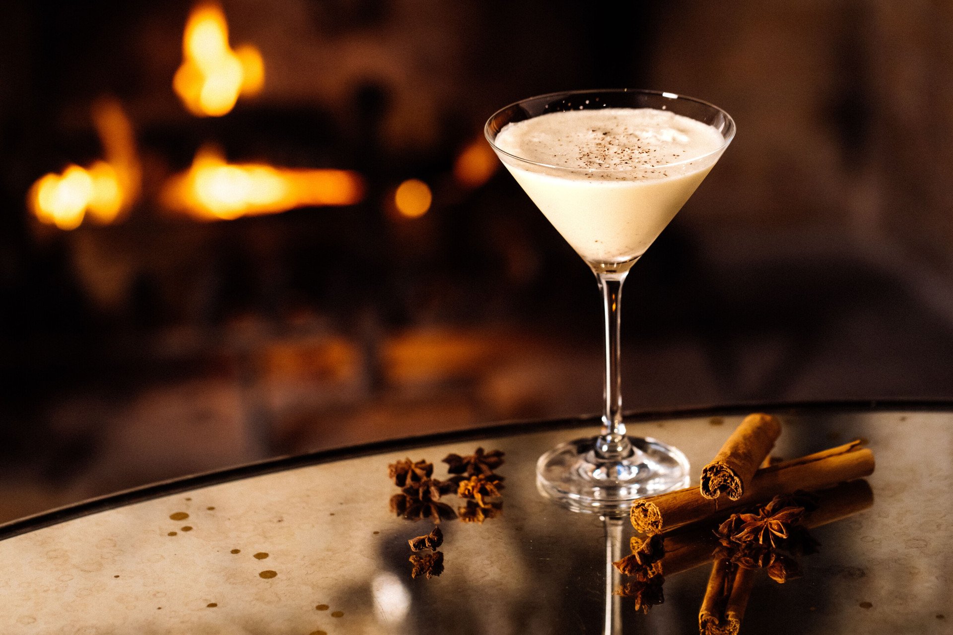 Eggnog martini on table with cinnamon sticks from the festive drinks menu in the Bar and Lounge at Hotel Bel-Air. 