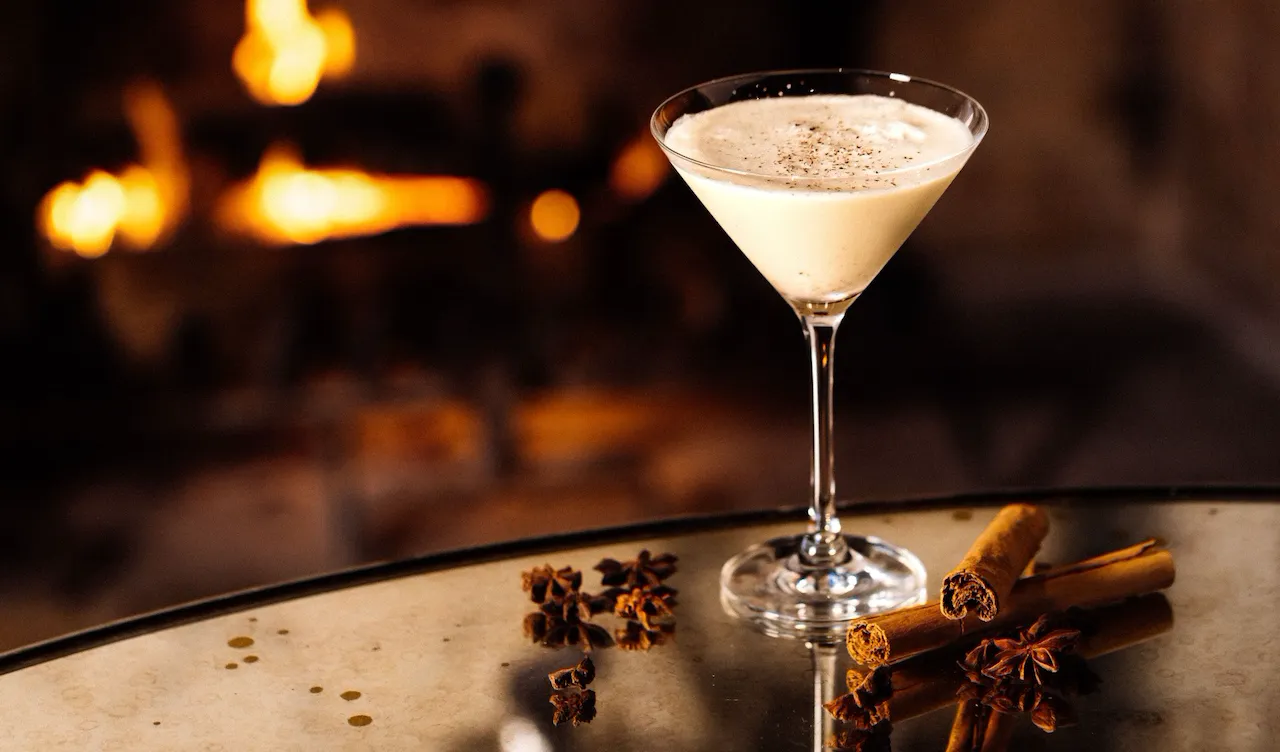Eggnog martini on table with cinnamon sticks from the festive drinks menu in the Bar and Lounge at Hotel Bel-Air.