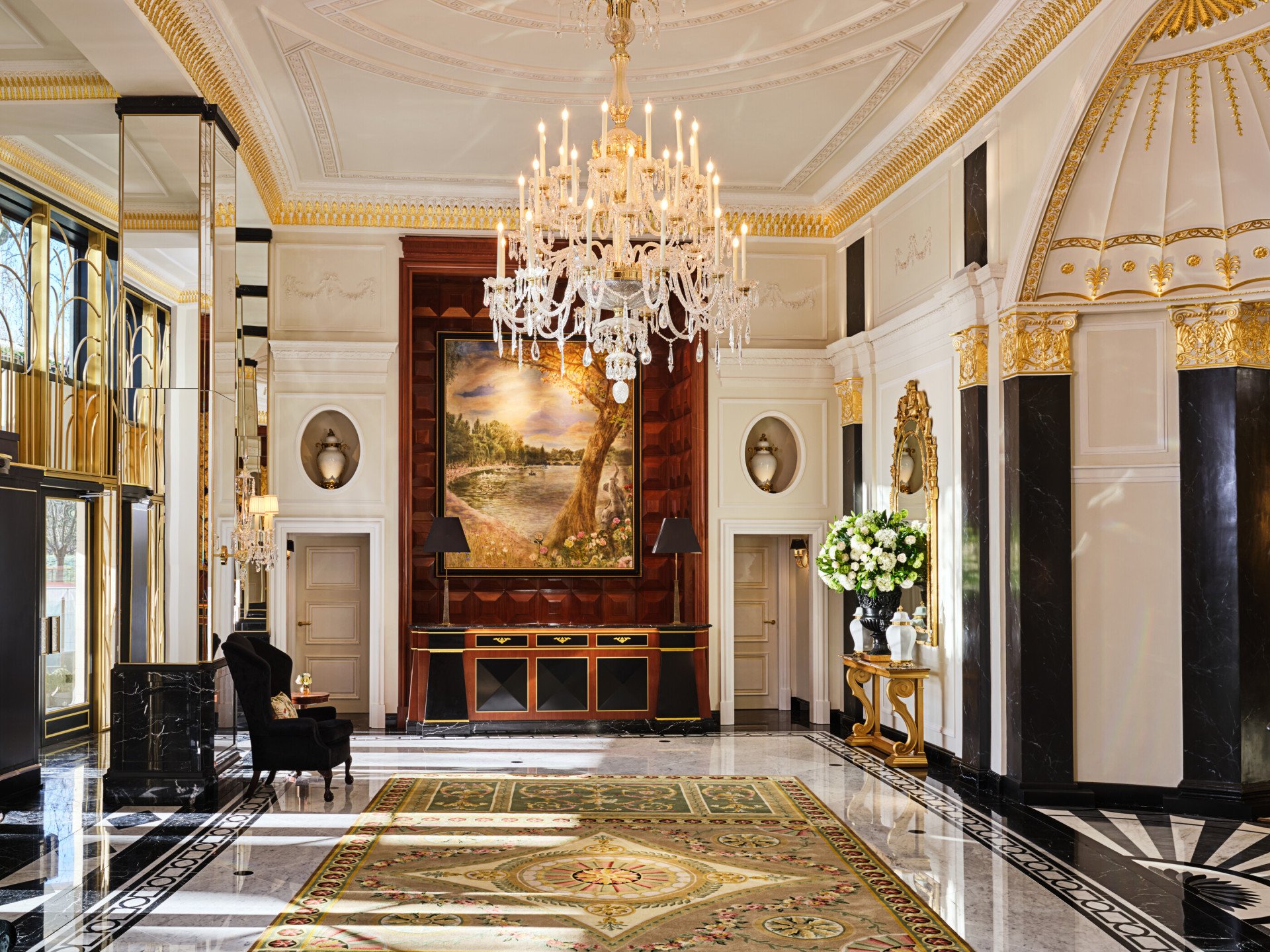 The Dorchester Lobby with reception desk and concierge desk in afternoon sunlight