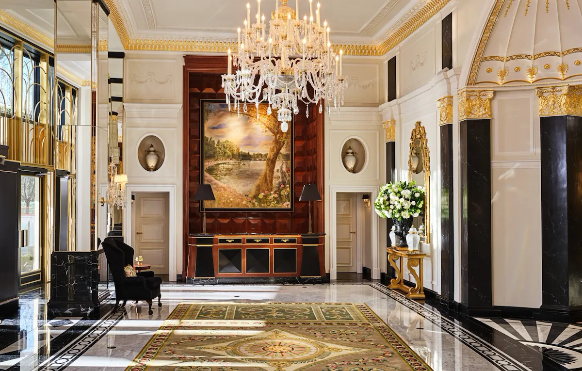 The Dorchester Lobby with reception desk and concierge desk in afternoon sunlight