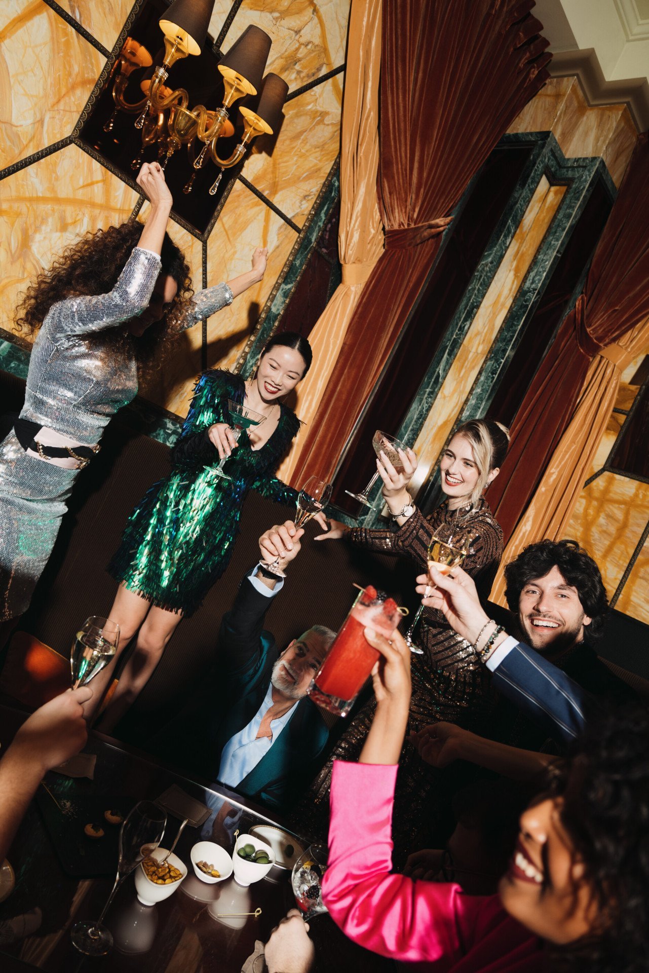 A group of people celebrating at Principe Bar and raising a toast