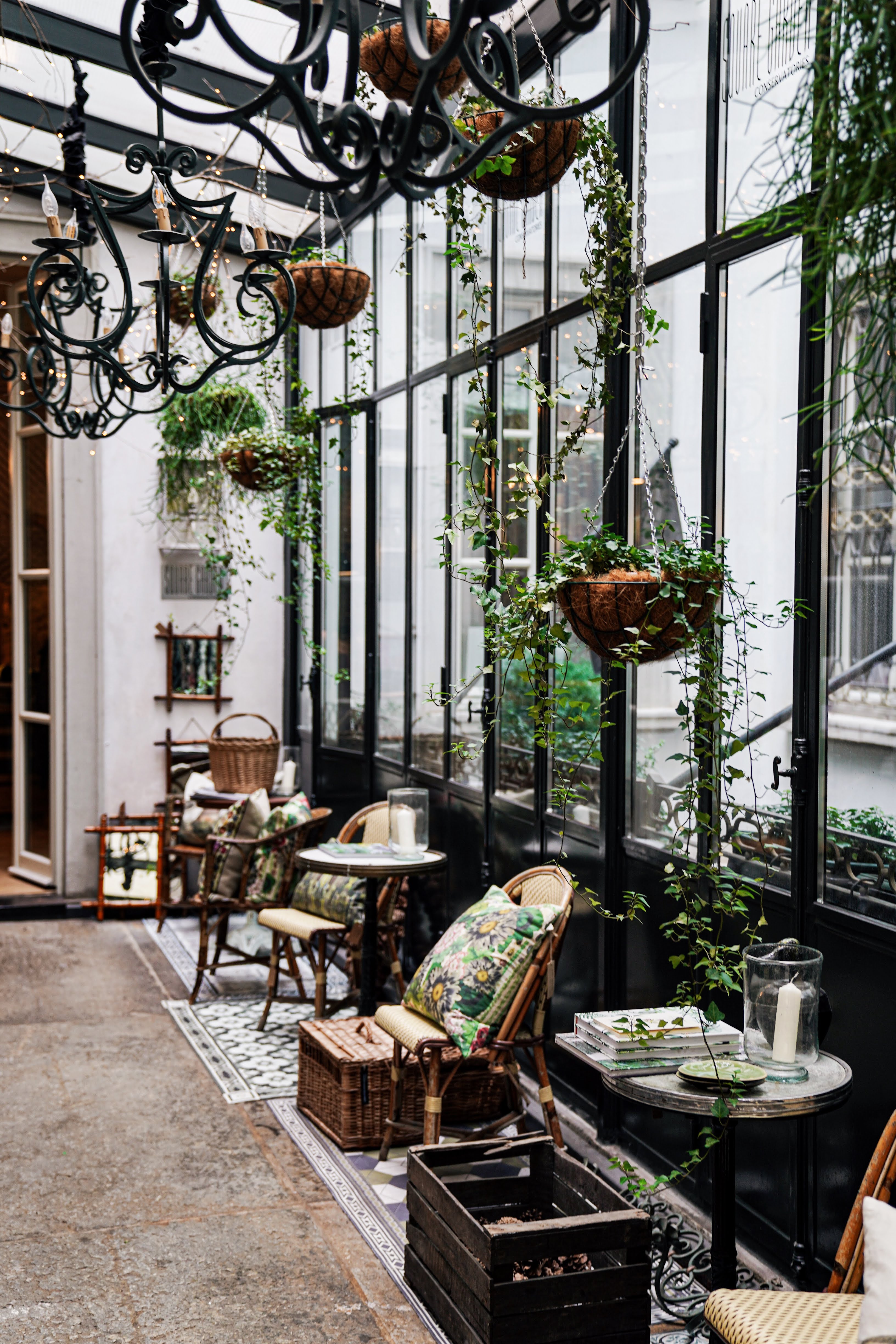 Raw&Co shop with large windows, chandeliers, chairs and antiques.