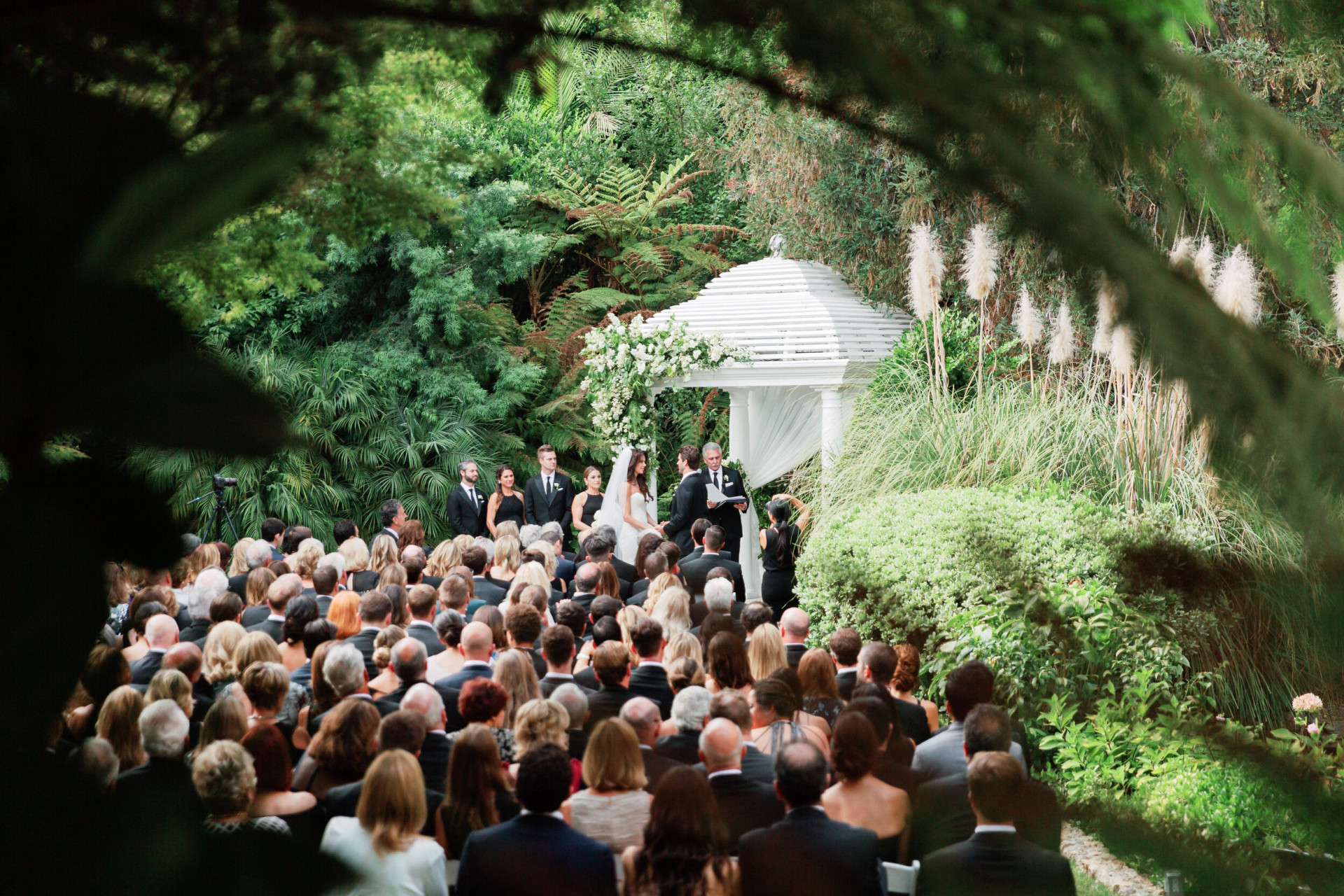Crowd gathers on Swan Lake for wedding at Hotel Bel-Air
