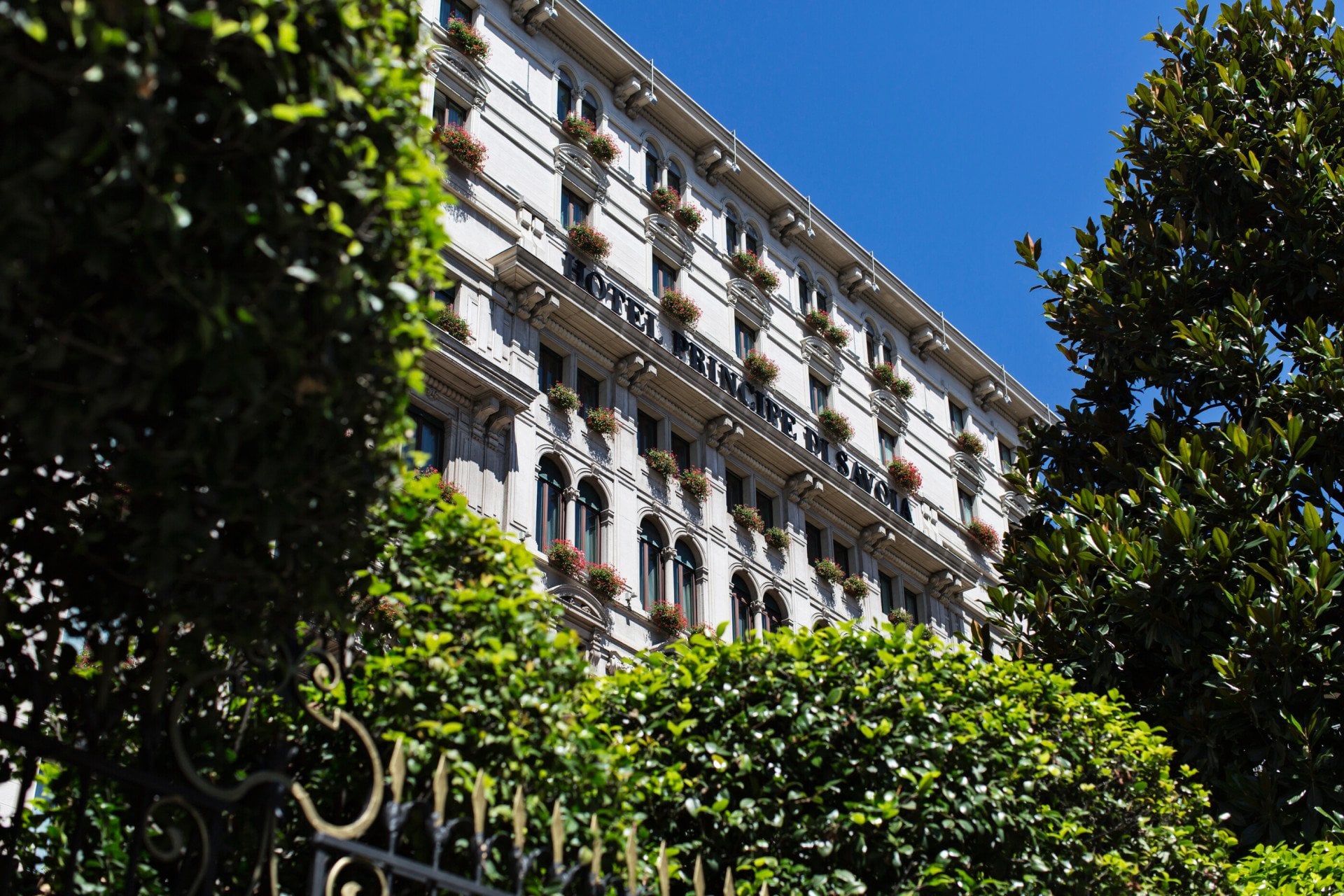 Exterior of Hotel Principe Di Savoia from ground level on a sunny day, Milan