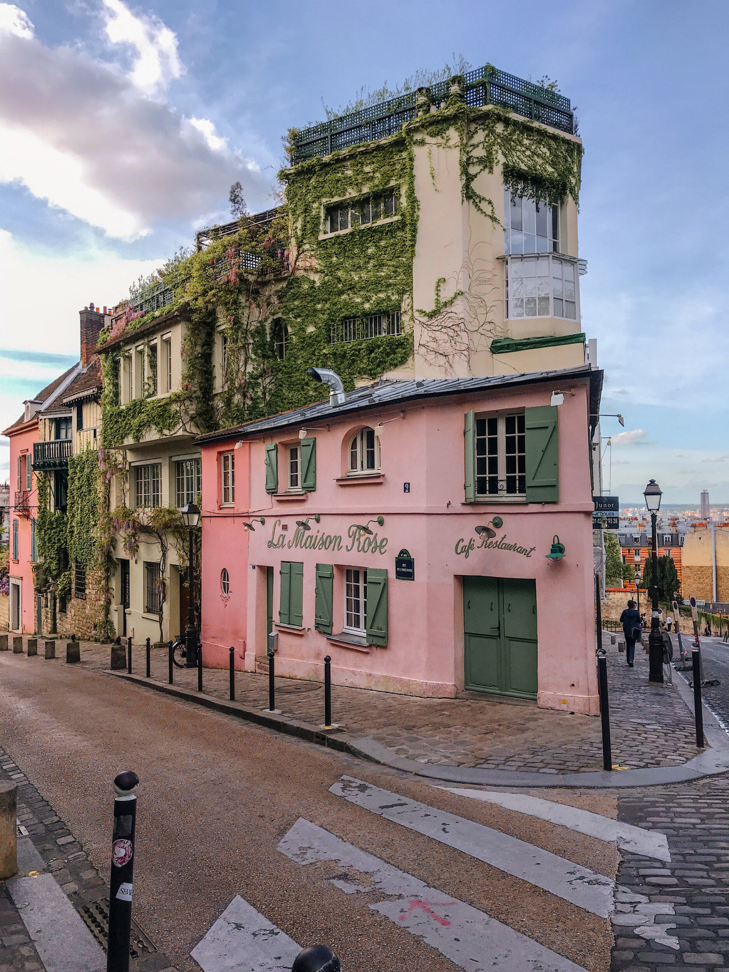 La Maison Rose restaurant façade in Montmartre, a piink façade with green doors and windows, at La Maison Rose, Paris.