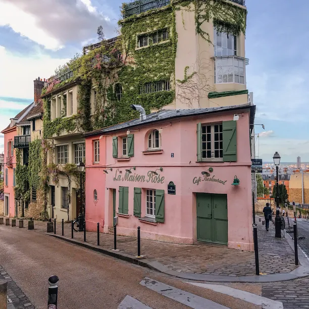 La Maison Rose restaurant façade in Montmartre, a piink façade with green doors and windows, at La Maison Rose, Paris.