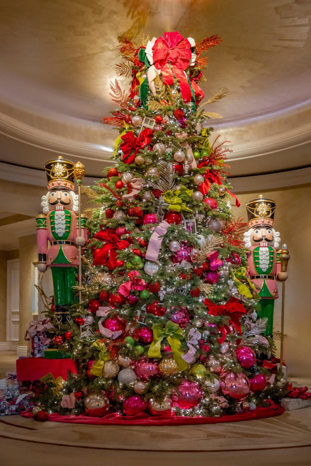 Pink and red decorated Christmas tree with oversized toy soldiers in The Beverly Hills Hotel lobby