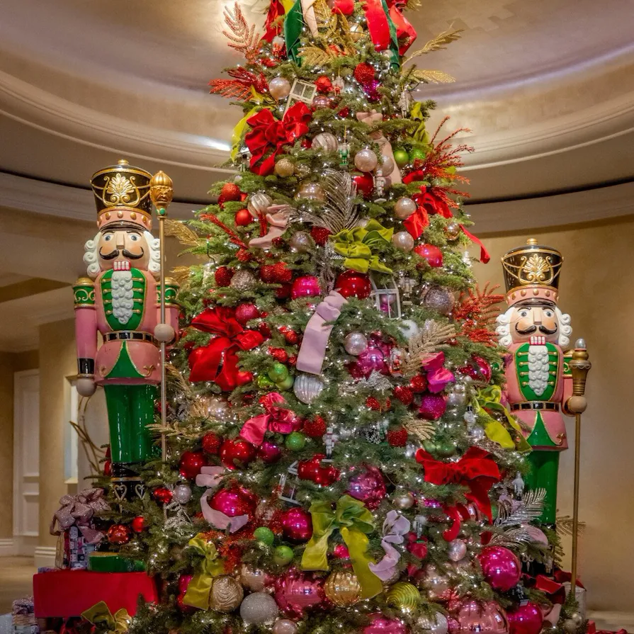 Pink and red decorated Christmas tree with oversized toy soldiers in The Beverly Hills Hotel lobby