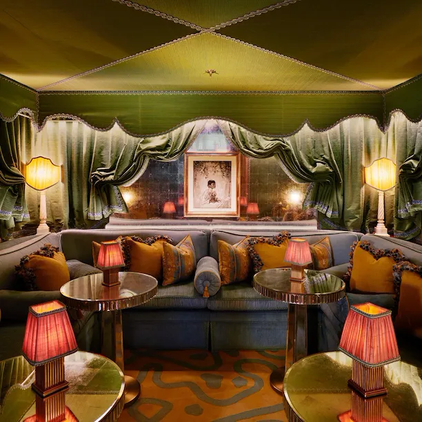 A cozy lounge with plush seating, warm lighting, and elegant curtains creating an inviting ambiance