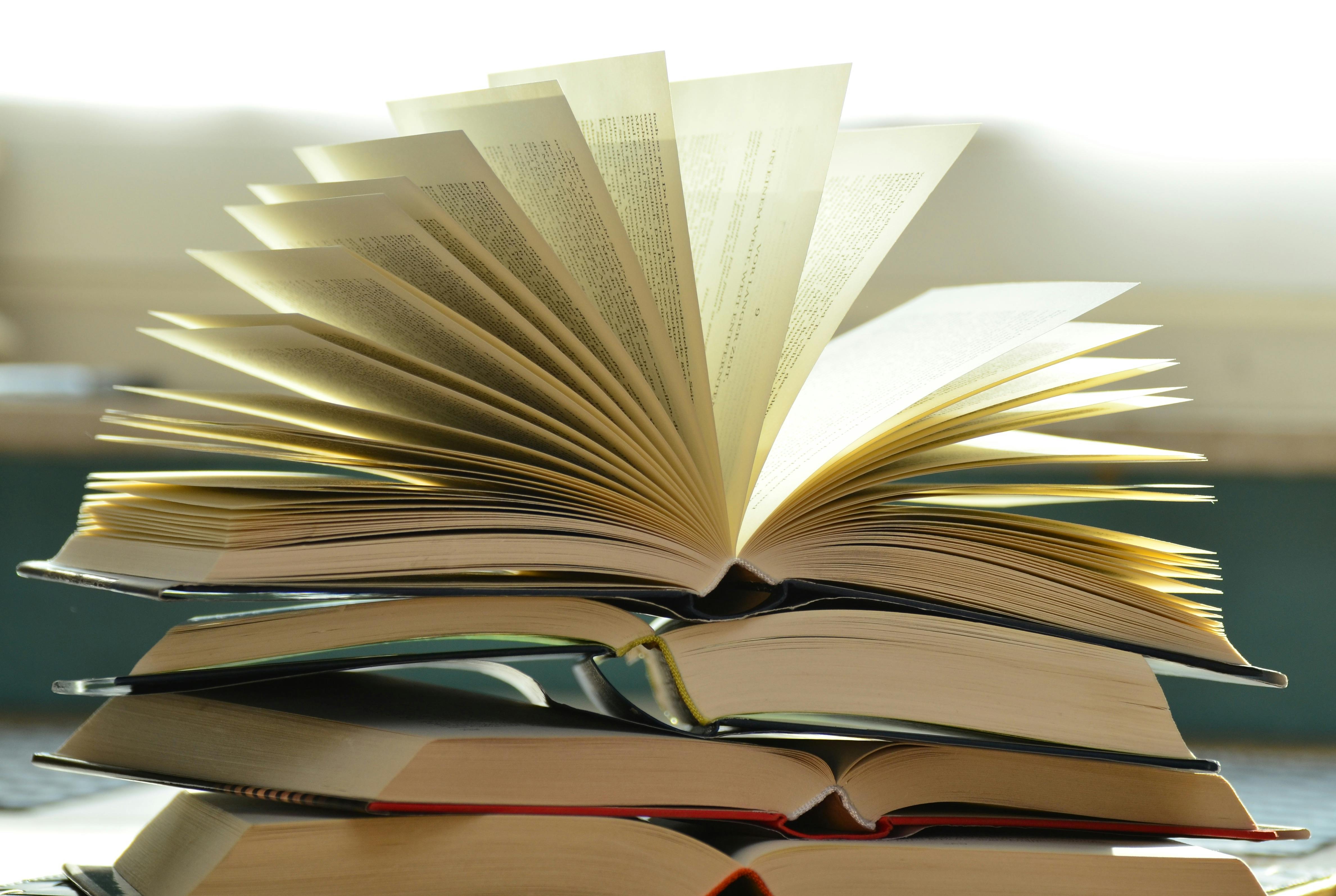 Close up view of stacked books on desk