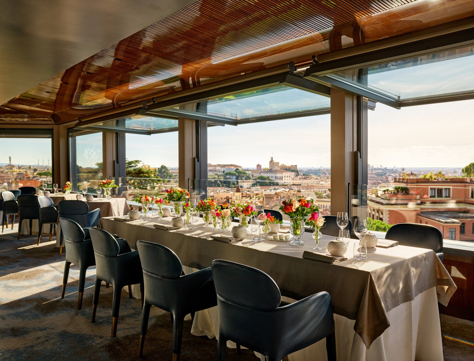 Table set up with flowers at La Terrazza with city view 