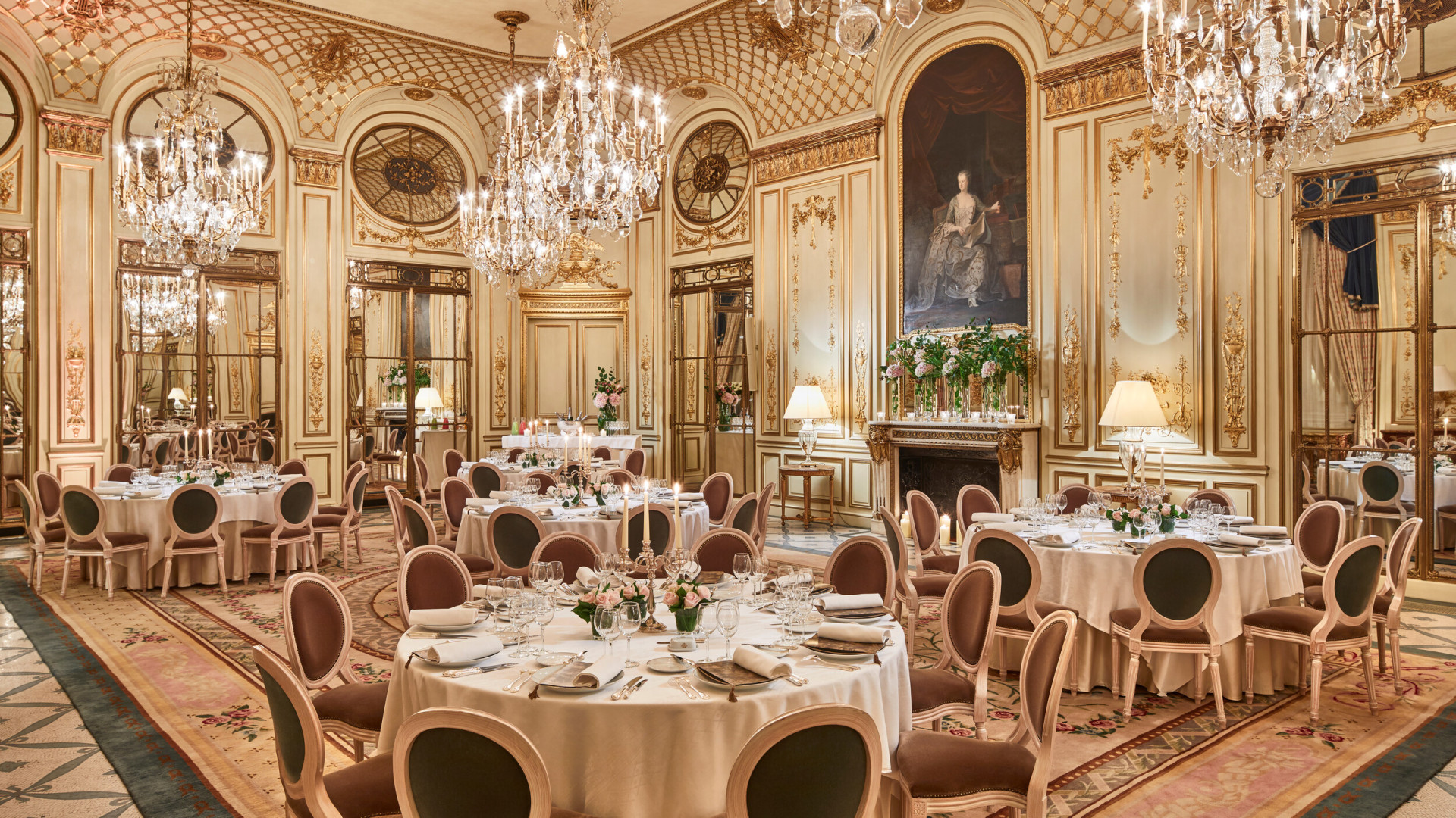 Photo of Salon Pompadour bright Versailles-style event room, set for dinner with four round and large dressed tables at Le Meurice, Paris