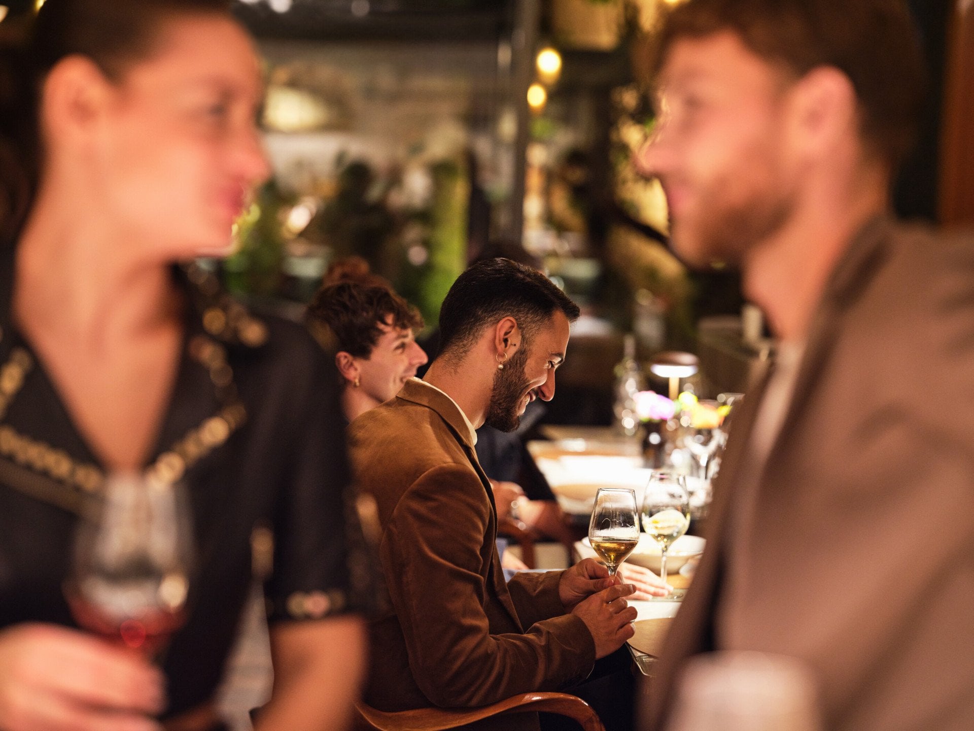 Close up of twosome at bar and people seated on the background seated at Il Giardino Ristorante