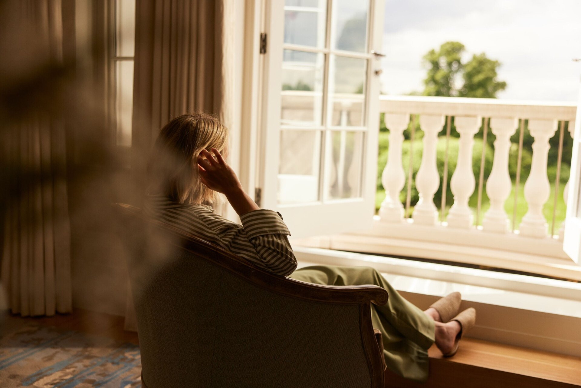 family relaxing and playing in room at Coworth Park