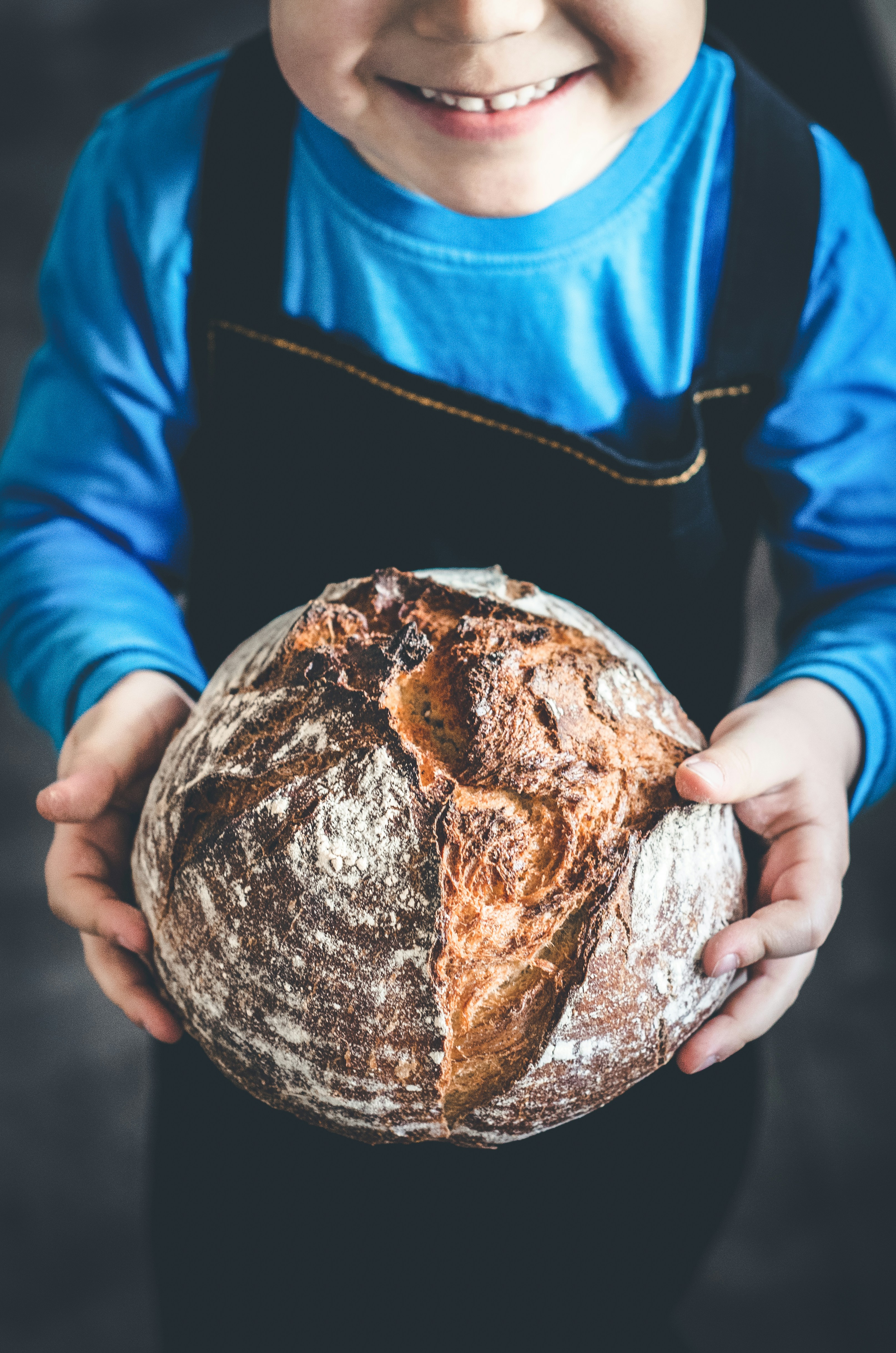 A child holding bread in his hands