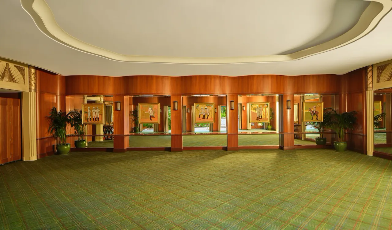 Empty conference room with windows, plants, and green carpet, calm and professional atmosphere