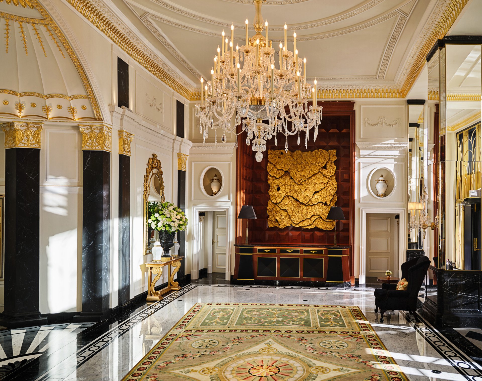 The Dorchester Lobby with reception desk and concierge desk in afternoon sunlight