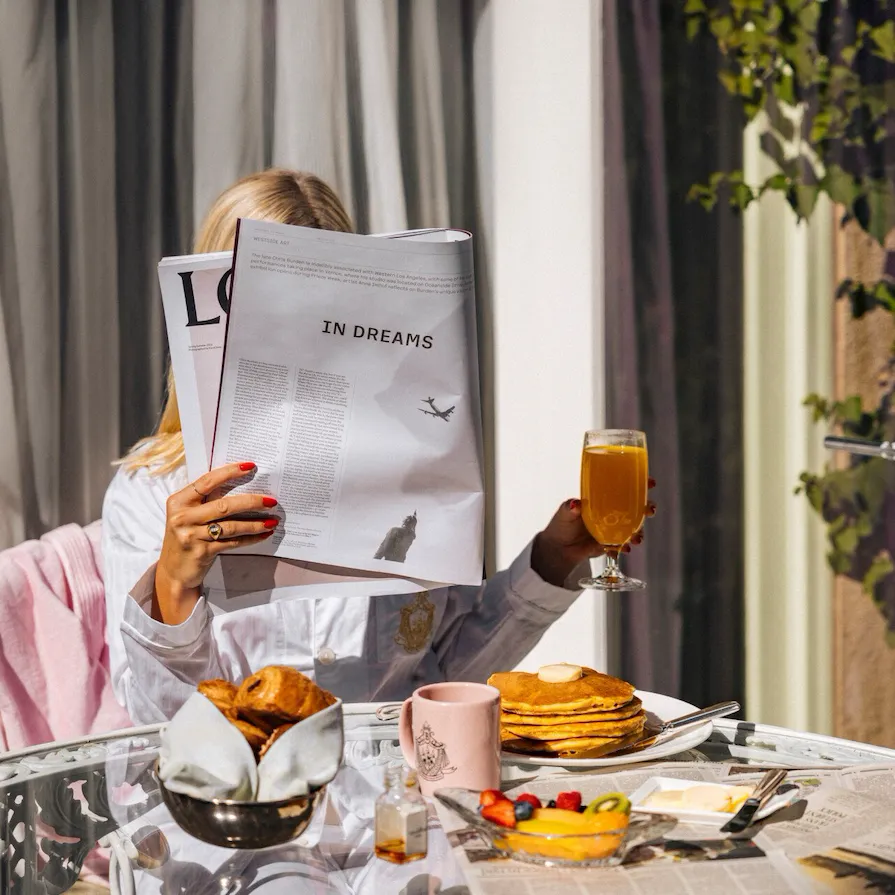 model enjoying room service on the patio