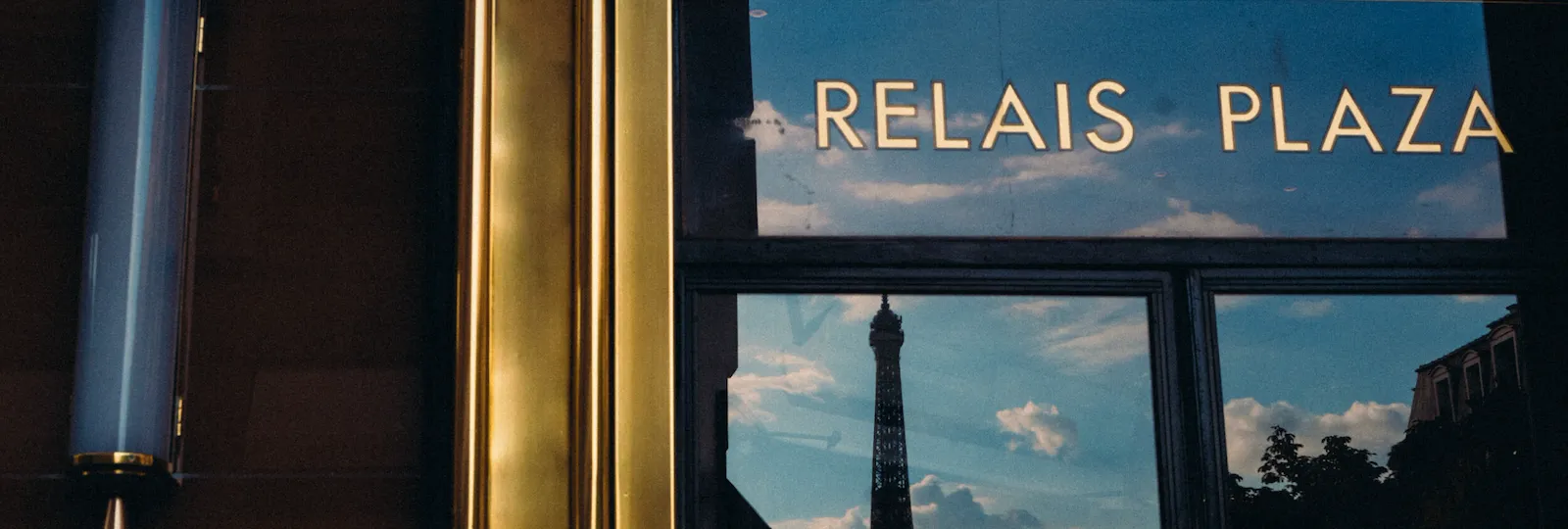 Eiffel tower reflection in the window of Le Relais Plaza, at Hotel Plaza Athénée, Paris