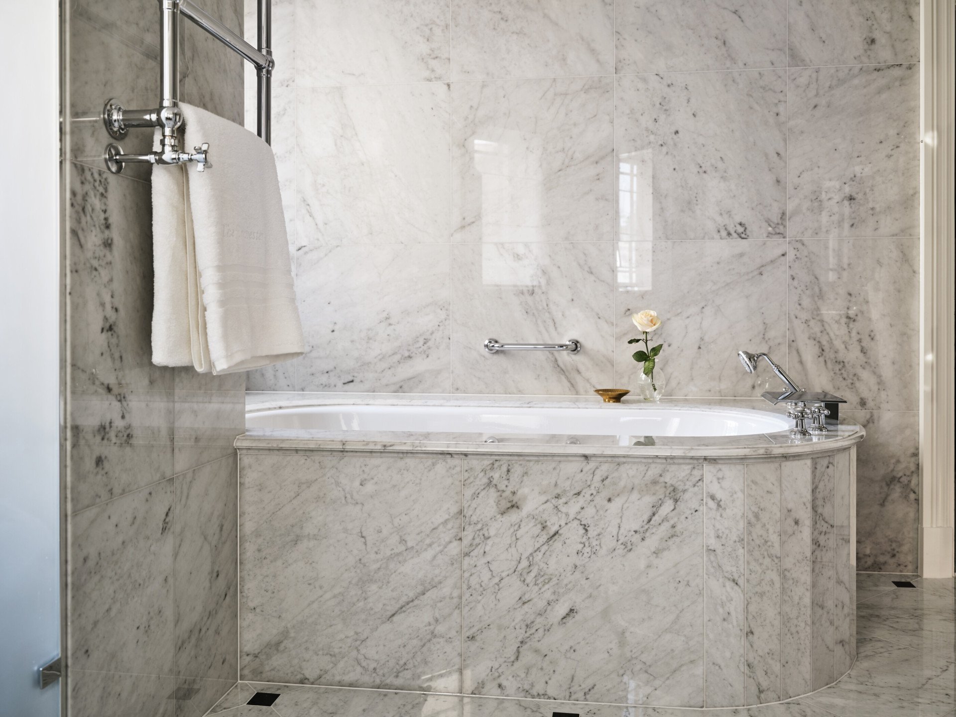 Dorchester Suite bathroom showcasing deep marble bathtub